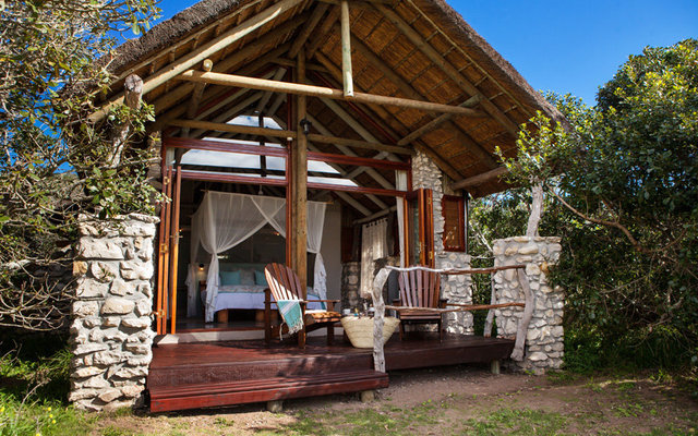 Stone and glass walls open onto private decks with gorgeous mountain views.  Each room has beautiful soft netting surrounding a king bed, a sitting area, writing desk, fireplace and ceiling fan. The bathrooms are fitted with a large romantic tub, copper sink and a private outdoor shower for an “African bush” experience.