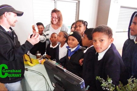Christoff Longland van Whale Coast Conservation beklemtoon die ekonomiese waarde van Fynbos aan Gansbaai Primêr se leerders,  met Marieta Rademeyer van die skool wat toekyk.  