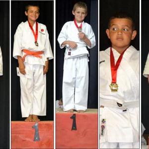 Pa Dawie en sy seun Harley Botha met hul medaljes.  Dawie het twee eerste plekke verower en Harley ‘n eerste en derde plek.  Mikayla Herselman wat ‘n eerste en tweede plek verower het. Andre Geerts spog met sy eerste plek. Hanlo van Rensburg spog ook  met ‘n eerste plek. Lehem Friendly, ‘n regte ‘soldaatjie’, het ‘n eerste plek  ingepalm. Nina  wat tweede geëindig het, staan heel links op die podium,  met haar ewebeeld, Zoë wat ‘n eerste en derde plek verower het tydens die klub se gordel-gradering.
