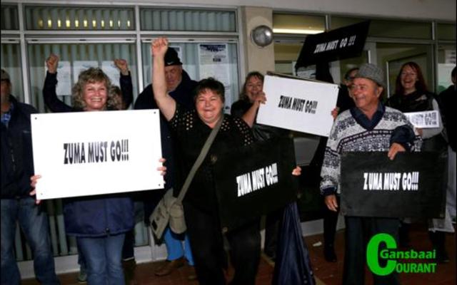 Hoewel hulle ernstig was oor dit waarvoor hulle staan, het optoggangers eers skuiling onder die biblioteek se afdak gevind, voordat hulle die reën aangedurf het.