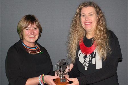 Outgoing PAAZA Chairman, Esther van der Westhuizen, hands over the award to DICT representative, Trudi Malan