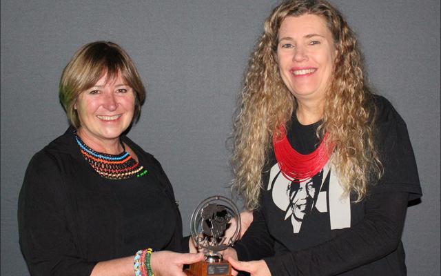 Outgoing PAAZA Chairman, Esther van der Westhuizen, hands over the award to DICT representative, Trudi Malan