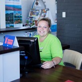 Doleen behind computer - Gansbaai Tourism Bureau - Xplorio™ Gansbaai