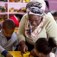 Teacher helping children