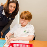 Teacher helping student with math