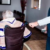 Nurse assisting resident