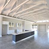 Exposed trusses with an Gorgeous open plan Kitchen