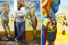 pringle_bay_outdoor_adventures_chadoka_art_studio_and_cycle_shop_owner_with_paintings_1536736136