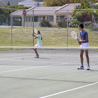 Teens playing tennis