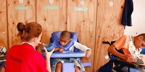Elim_home_volunteer_feeding_child_1518417993_1573474963