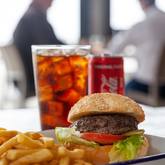 Xplorio™ Struisbaai - Catch Cook Restaurant - 200g Local grass fed beef burger served on a toasted sesame bun with tomato, lettuce, house sauce and chips. Add toppings: - caramelised onions- cheddar, mozzarella, feta- cheese sauce, garlic sauce, avo