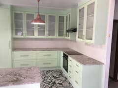 Kitchen with Granite Tops and Pistachio Green Doors and Panels